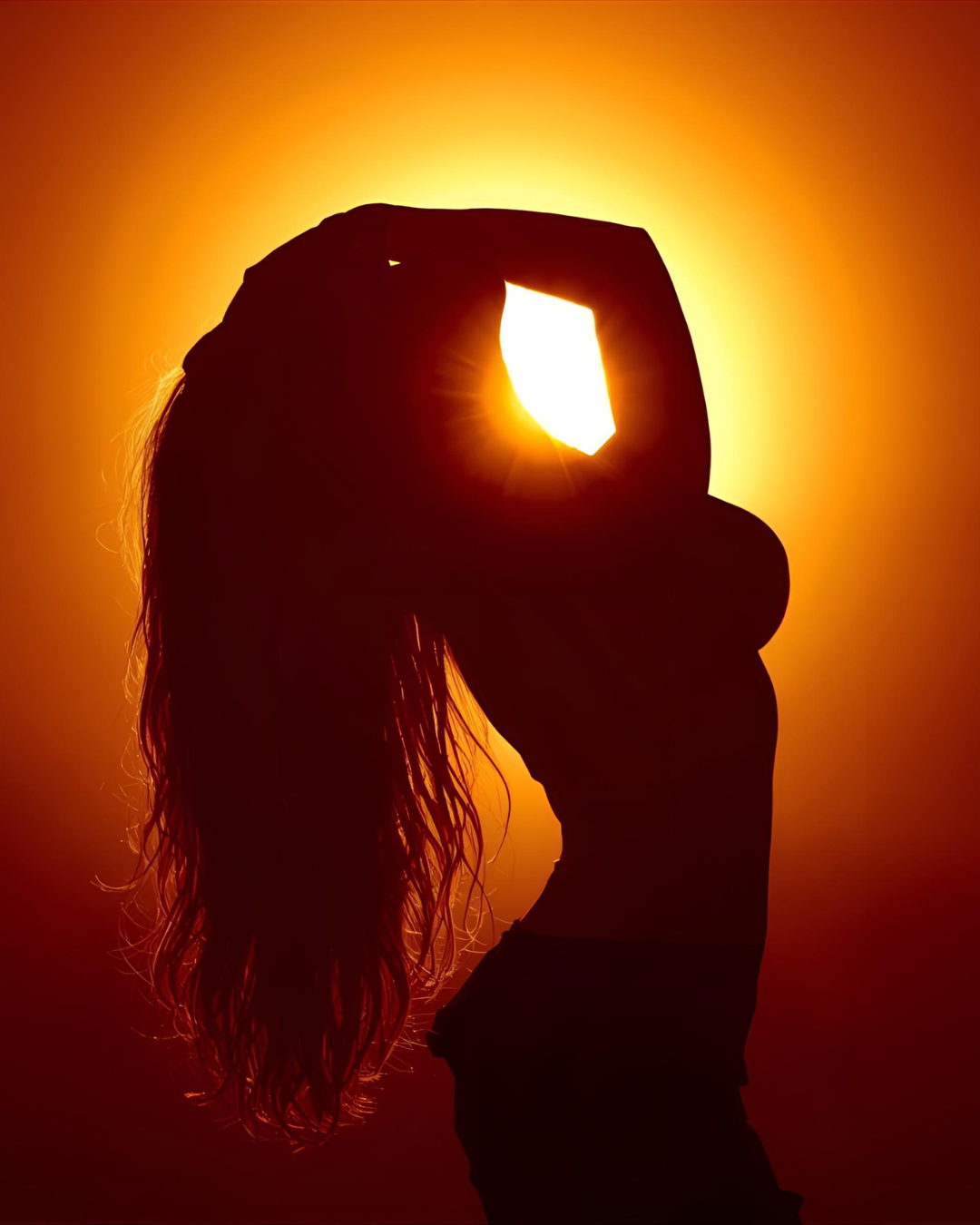 Silhouette of a woman arching in surrender beneath a golden glow, symbolizing rebirth and inner fire; warm tones of amber and crimson evoke transformation and empowerment.